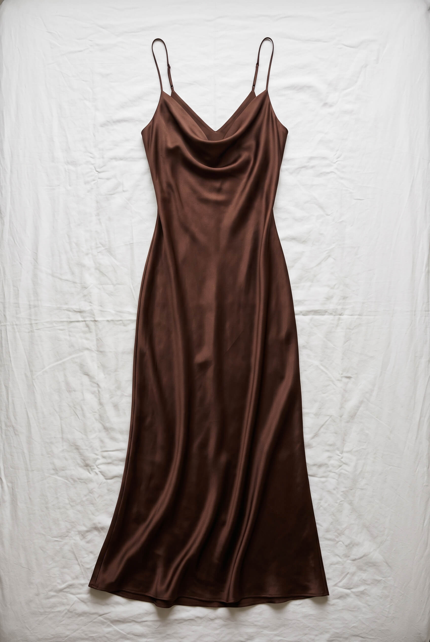 Brown satin slip dress photographed flat on white linen, used as the reference image
